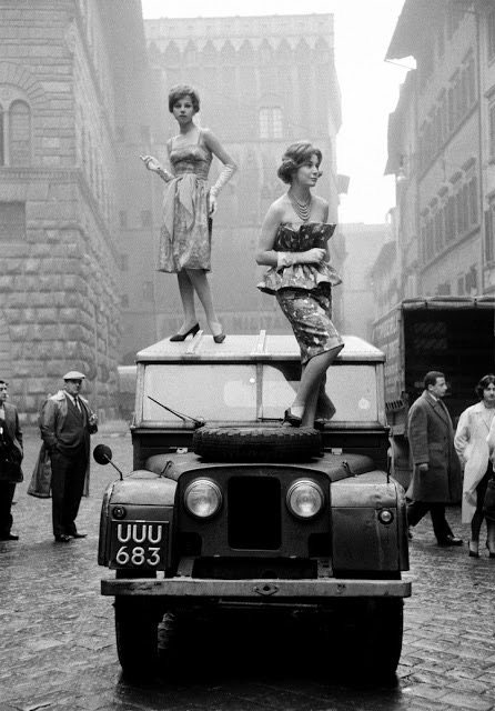 Two+fashionable+girls+standing+on+the+roof+of+a+Jeep+in+Florence%2C+Italy%2C+1958